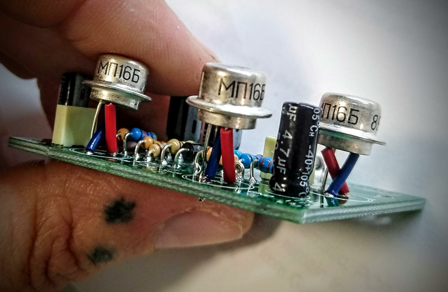 Between the thumb and forefinger of Jason Sunderland is a small array of transistors and capacitors that will pump a special sound into his bass guitar.